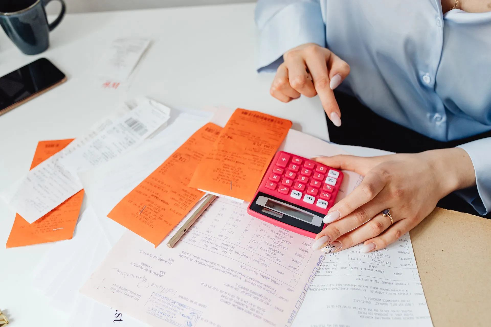 Receipts and calculator being organised for bookkeeping E P Accountants Worcestershire